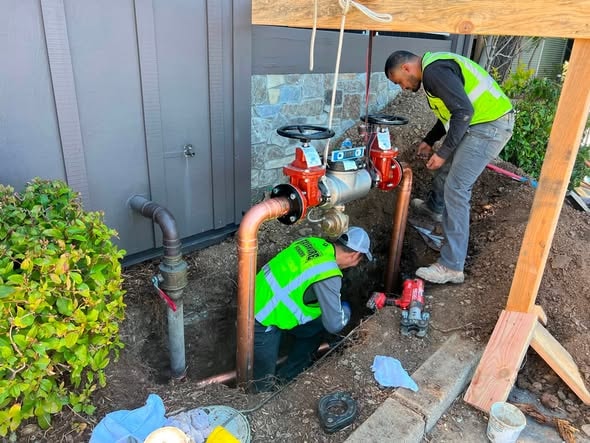 Crew installing pipe valves and fittings